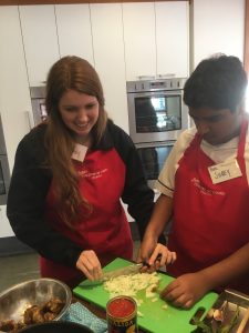 PAIS Volunteer Kassidy assisting Westside student at Ministry of Food